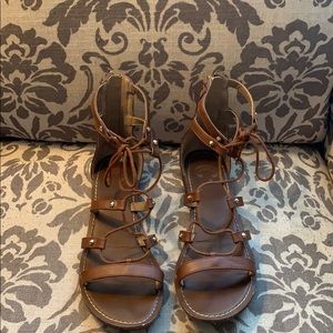 Brown lacy sandals with gold accents